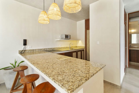 Savor every bite in our inviting dining space, perfect for enjoying the culinary delights with the warm glow of Tulum's ambiance.  #DiningExperience #WarmAmbience #TasteOfTulum