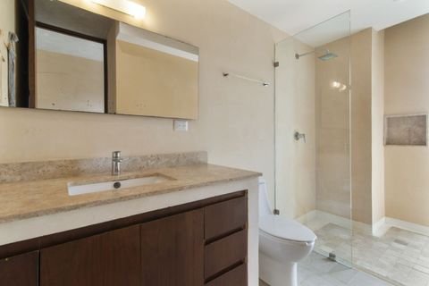 Modern full bathroom with walk-in glass shower, marble countertop, sleek fixtures, and soft lighting — designed for comfort and relaxation during your stay.
