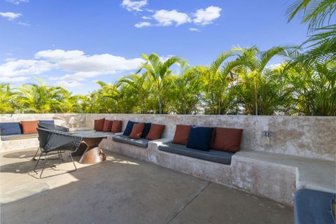 Cozy rooftop corner with built-in seating, colorful cushions, and lush greenery—perfect for lounging and enjoying the sunshine or evening breeze.