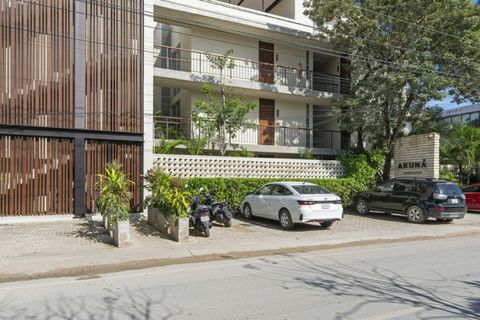 Modern and secure exterior of Aruna Residences with private parking and lush greenery.