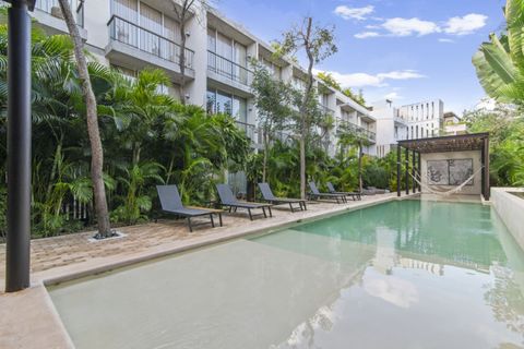 Lush tropical backyard with a refreshing shared pool, loungers for sunbathing, and a hammock lounge area for relaxing under the pergola. Perfect spot to unwind outdoors!