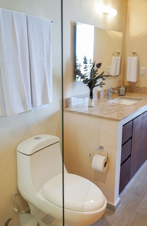 All bathrooms have a similar style with a walk in shower, a toilet and a faucet with plenty of storage space