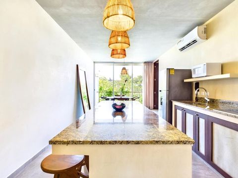 The open layout of the kitchen seamlessly flows into the living area, creating a perfect environment for entertaining friends and family during your vacation.