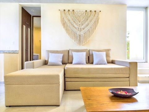 Relax in the cozy living room featuring a large sofa bed, providing comfortable sleeping space for two additional guests and perfect for movie nights.
