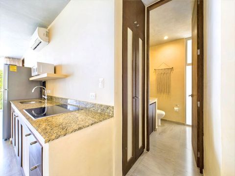 In addition to the full bathroom, an extra half bathroom is conveniently located near the kitchen, offering privacy and ease for guests during their stay.