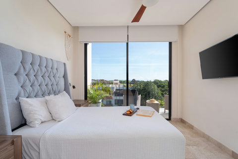 Spacious king-size second bedroom with en suite bath and private balcony. Perfect for relaxing, enjoying privacy, and soaking in tranquil views from your own comfortable retreat.