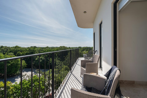 Step onto the second bedroom’s private balcony with comfortable seating and beautiful views—perfect for relaxing, enjoying a quiet read, or sipping a drink in peaceful surroundings.