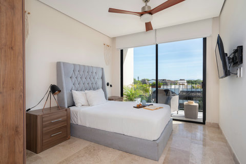 Spacious king-size second bedroom with en suite bath and private balcony. Perfect for relaxing in comfort, enjoying privacy, and taking in tranquil views from your own cozy retreat.