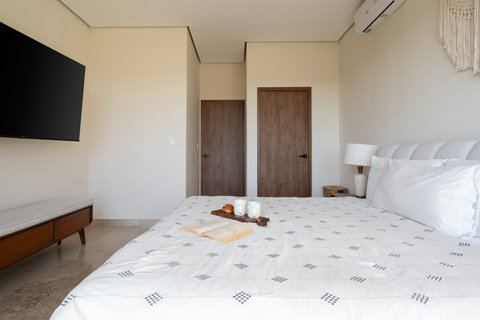 Relax in our king-size suite featuring an ensuite bathroom, generous storage, a smart TV, and a serene private balcony—ideal for unwinding, enjoying quiet moments, and soaking in the peaceful atmosphere.