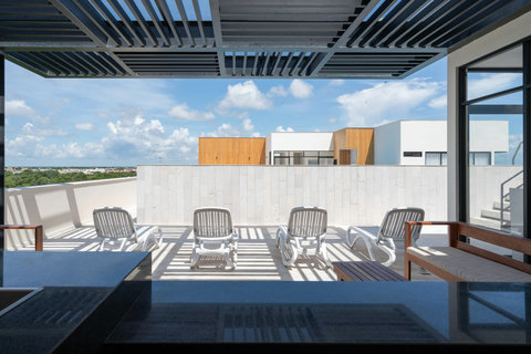 The rooftop deck is your perfect retreat, featuring sunbeds and seating areas for a tranquil day of sun, relaxation, and enjoying stunning surroundings.