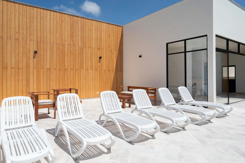 Relax on the rooftop deck with plenty of sunbeds and cozy seating areas—perfect for soaking up the sun, reading a book, or enjoying peaceful moments with friends.