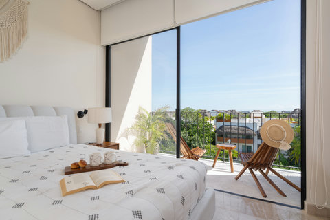 Retreat to our king-size suite with a cozy balcony, large windows, and a serene private space—perfect for relaxing, recharging, and savoring peaceful, tranquil moments.