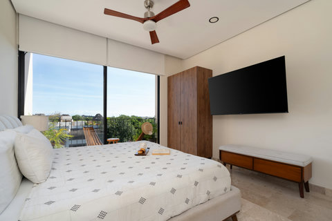 Escape to our king-size suite featuring an ensuite bathroom, spacious closet, smart TV, large windows, and a peaceful private balcony—ideal for relaxing, recharging, and enjoying serene moments.