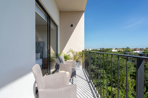 Enjoy the second bedroom’s private balcony, featuring cozy chairs and stunning views—ideal for relaxing, reading, or sipping a drink while taking in the serene surroundings.
