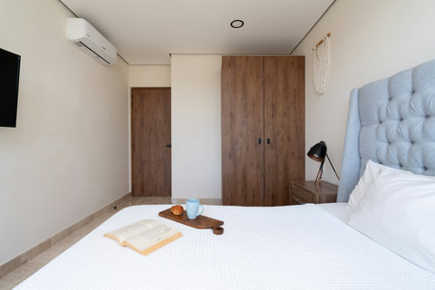 Relax in our second bedroom featuring a king-size bed, Smart TV, and private balcony. Perfect for peaceful moments, unwinding after a day, and enjoying serene views in comfort.