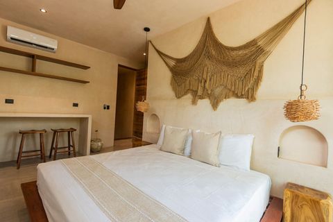 Cozy  bedroom with a sleek wall-mounted TV,  king size bed , rustic woven pendant light, and minimalist decor. The open shelving and bar area add a stylish, functional touch.