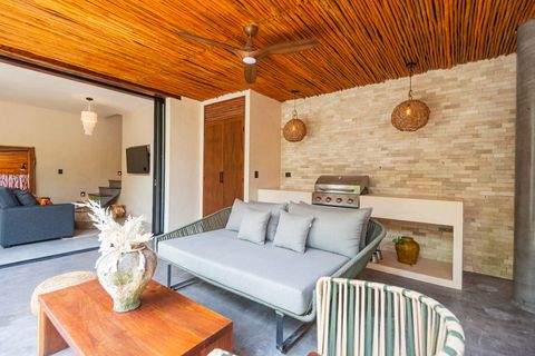 Stylish outdoor lounge featuring a built-in grill, comfortable seating, and a rustic wooden ceiling. A perfect blend of comfort and nature.