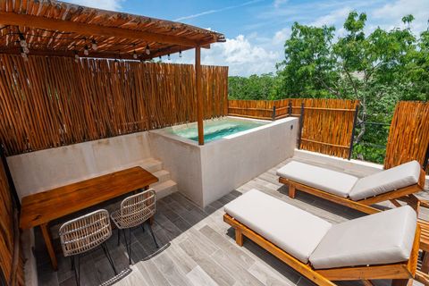 Private rooftop terrace featuring a plunge pool, sun loungers, and a bamboo pergola. A peaceful escape with breathtaking views of nature.