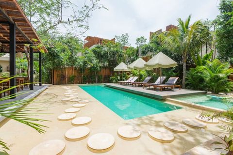 Serene poolside retreat featuring sun loungers, umbrellas, and tropical landscaping. A peaceful oasis for relaxation and sunbathing.