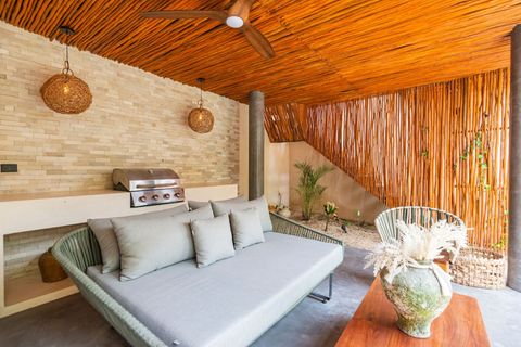 Cozy outdoor retreat with a bamboo-accented ceiling, rattan pendant lights, and an inviting lounge area. A serene escape with natural textures.