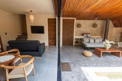 Seamless indoor-outdoor living with stylish décor, a cozy seating area, and a built-in BBQ for the perfect tropical retreat.