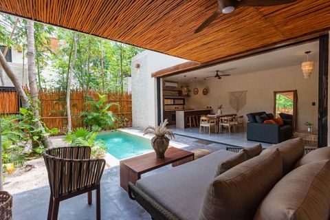 Tranquil private patio with a plunge pool, surrounded by lush greenery. A cozy seating area creates a perfect spot for relaxation.
