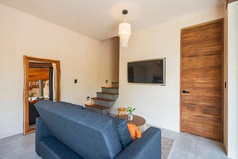 Modern living space with warm wooden accents, a smart TV, and an open design that connects to the private pool area.