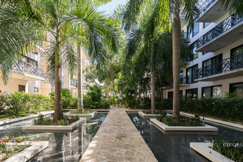 Enjoy a serene tropical courtyard filled with tall palms, gentle water features, and beautifully landscaped paths. It’s the perfect outdoor escape for morning walks or quiet moments in nature.