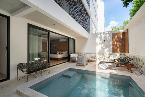 Relax in a private patio featuring a plunge pool, sun loungers, and abundant natural light. Perfect for soaking up the sun, unwinding, or enjoying peaceful moments outdoors.