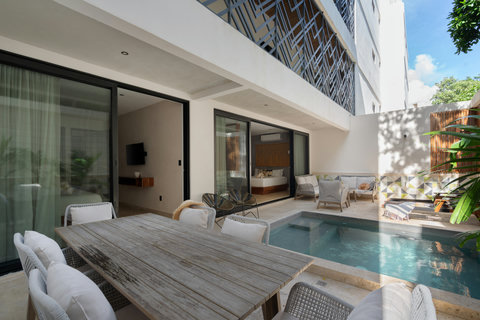 This private patio offers a plunge pool and a fully equipped outdoor dining area. Guests can unwind, dine, or enjoy peaceful moments in a comfortable and secluded setting.