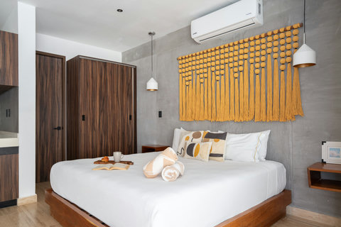 Spacious bedroom featuring a comfortable king-size bed, air conditioning, and a closet. Designed for ultimate relaxation, it’s the perfect place to rest and recharge after a long day.