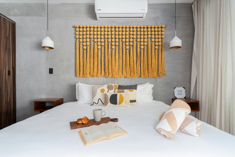 Spacious bedroom with a comfortable king-size bed and air conditioning. Designed for ultimate relaxation, it’s the perfect spot to unwind, rest, and recharge after a long day.