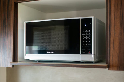 The kitchen is equipped with a sleek, modern Galanz microwave, perfect for quick and easy meal preparation.