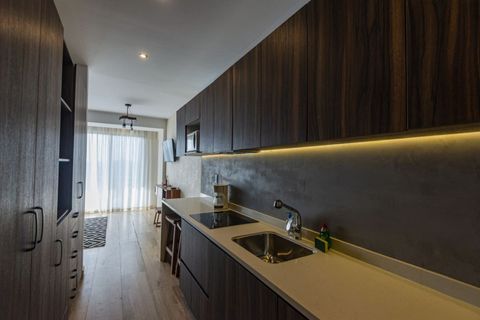Experience culinary delight in our fully equipped kitchen, adorned with stunning wooden elements, harmonizing style and functionality seamlessly.