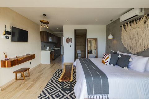 Elegant retreat: Luxurious king-size bed, private bath, smart TV, adorned with exquisite decor—a haven for sophisticated relaxation.