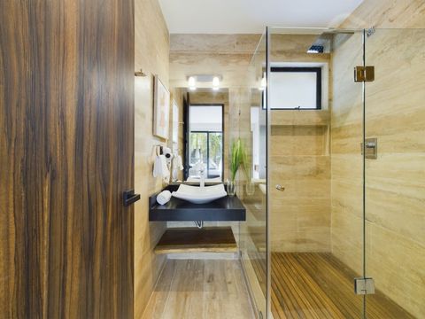 Experience luxury in the master bathroom, featuring a spacious rain shower, a separate toilet area, and a generously sized sink—designed for your comfort and convenience.
