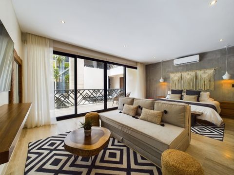 Experience comfort at its finest in our inviting living space, featuring abundant natural light, a cozy sofa, and a king-size bed for an ideal retreat.