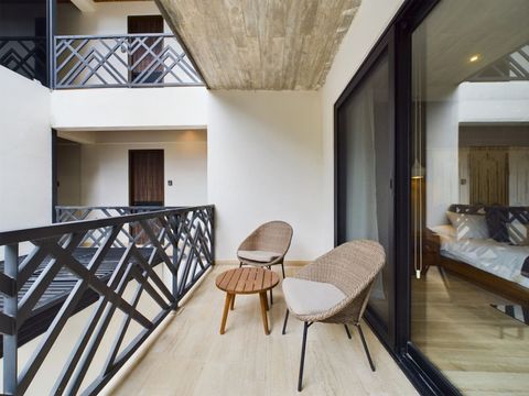 On the balcony, you'll discover inviting areas to socialize with friends and family, making it an ideal spot for relaxation and connection.