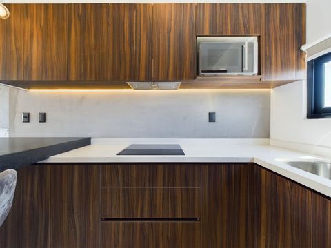 Indulge in a stunning, contemporary kitchen featuring a minimalist design, ideal for creating culinary wonders with ease and sophistication.