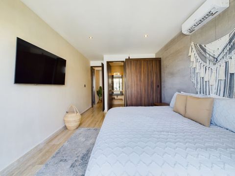 Indulge in luxury at the master bedroom, complete with a spacious king-size bed, a Smart TV, a cozy sofa, and expansive windows, fulfilling every desire.