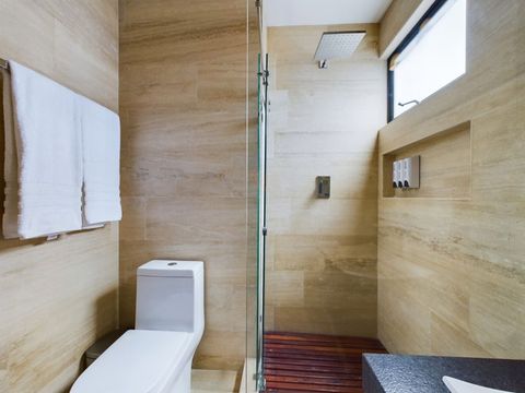 Discover luxury in the master bathroom, adorned with a lavish rain shower, private toilet area, and an expansive sink. Embrace comfort and convenience redefined.