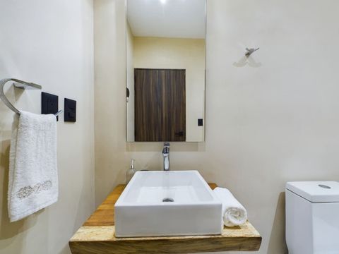 The bathroom, contemporary and pristine, is equipped with all essentials for your comfort, ensuring a relaxing stay