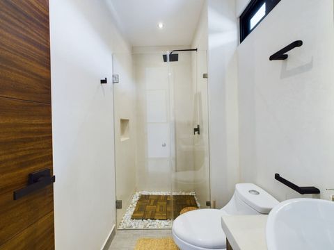 The bathroom is a full bathroom with a large rain shower, a separate toilet and a plenty of storage space too.