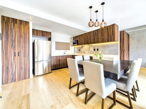 The dining area benefits from a large dining table which can sit up 6 people comfortably. You will also enjoy the large American fridge where you can stock up on essentials and drinks. If you plan to cook meals at home you will have all the material