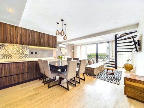This is the view of the apartment as you walk in towards your left with the second bedroom, and the kitchen and dining area. The living space is big and comes fully equipped.