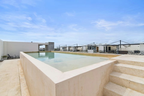 Take in rooftop views from this serene infinity-edge pool, complete with sunny lounge chairs and modern, minimalist design—perfect for relaxing above it all.
