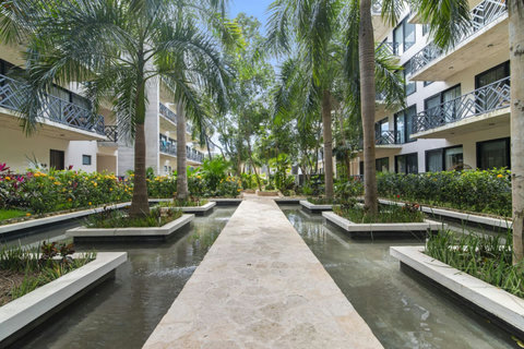 Immerse yourself in the lush beauty of our shared gardens, where vibrant greenery and tranquil water features create the perfect escape in nature.