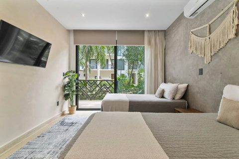 Discover our cozy second bedroom, featuring two individual beds with plenty of storage space and stylish decor for your comfort.