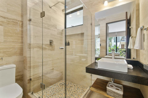 Experience the comfort of large ensuite bathrooms featuring refreshing rain showers, perfect for unwinding after exploring Tulum!