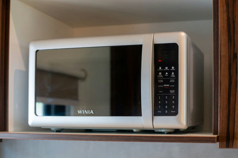 Prepare quick and easy meals with the convenience of a new microwave, designed for guests who appreciate efficiency in the kitchen.
